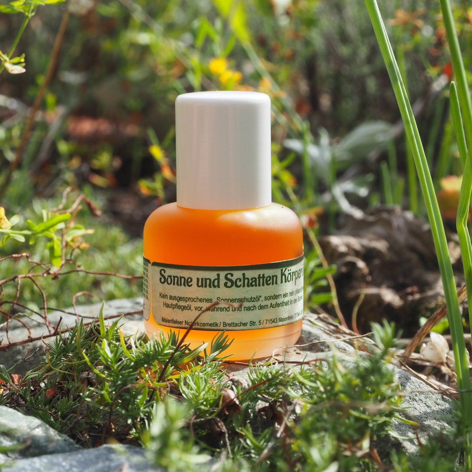 Sonne und Schatten Körperöl 15ml im Hintergrund Moos, Blüten und Gräser